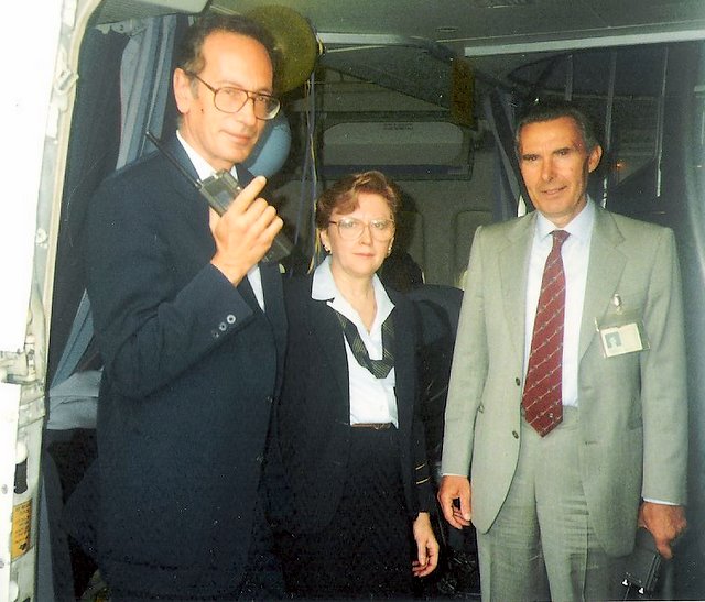 1980s Purser, Peggy Catalano,  poses in the doorway of a Pan Am Boeing 747 with Rome Station Manger on her left and Rome Catering Manager (with radio) on her right.